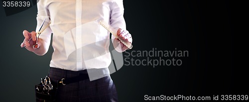 Image of close up of male stylist with scissors at salon