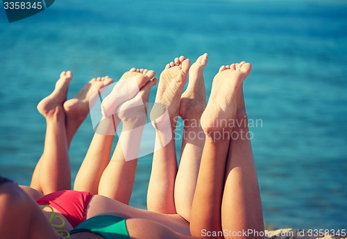 Image of close up of young women lying on beach