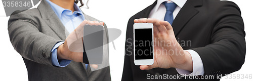 Image of businessman and businesswoman with smartphones
