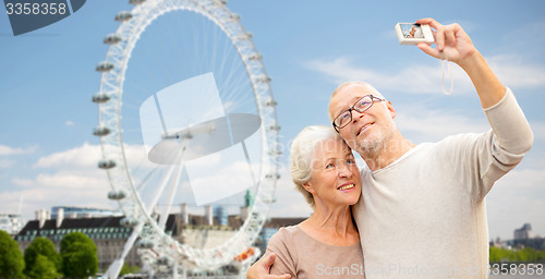 Image of senior couple selfie with camera over london