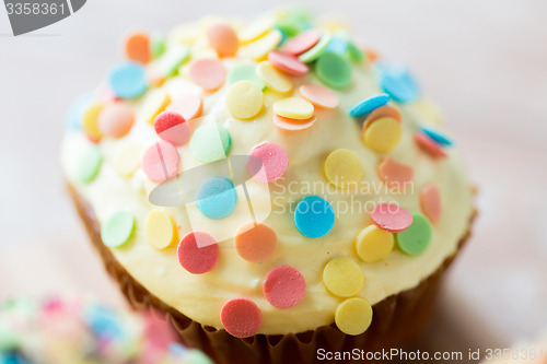 Image of close up of glazed cupcake or muffin on table