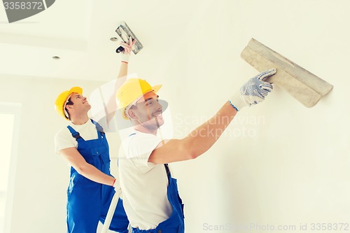 Image of group of builders with tools indoors