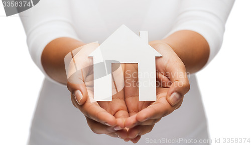 Image of woman hands with paper house