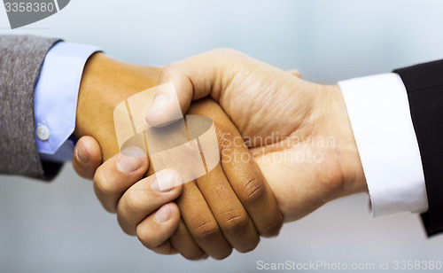 Image of businessman and businesswoman shaking hands