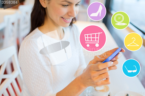 Image of smiling woman with smartphone shopping online