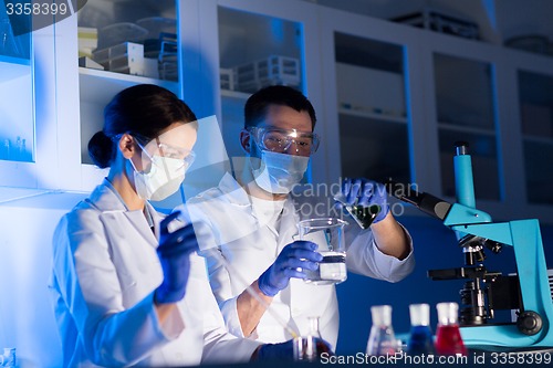 Image of close up of scientists making test in lab