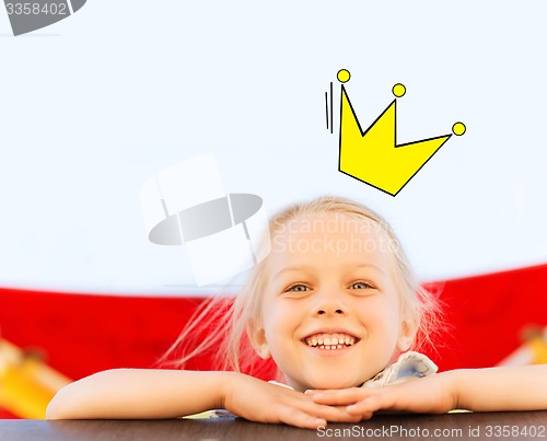 Image of happy little girl climbing on children playground