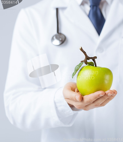 Image of male doctor with green apple