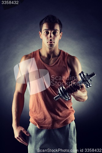 Image of young man with dumbbell