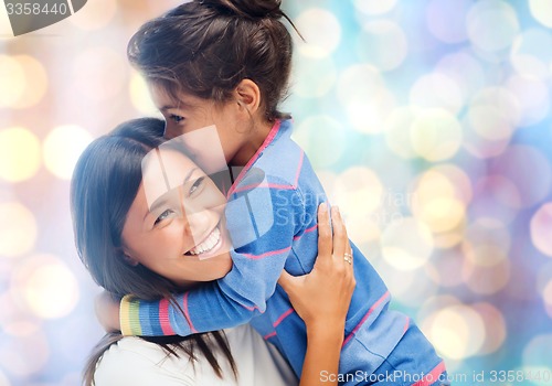 Image of happy mother and daughter hugging