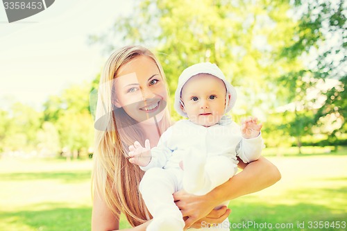 Image of happy mother with little baby in park