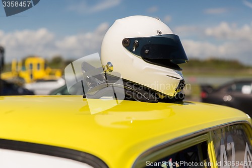 Image of close up of car with helmet on roof top