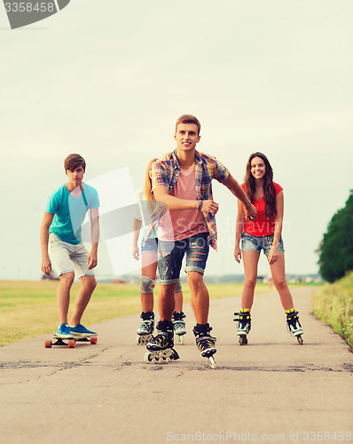 Image of group of smiling teenagers with roller-skates