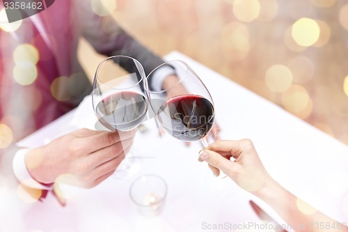 Image of young couple with glasses of wine at restaurant