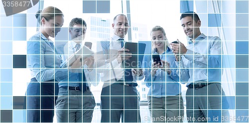 Image of business people with tablet pc and smartphones