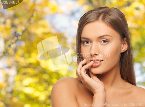 Image of beautiful young woman with bare shoulders