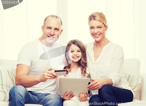Image of parents and girl with tablet pc and credit card