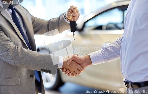 Image of close up of handshake in auto show or salon