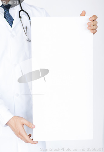 Image of doctor holding blank white banner