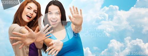 Image of happy girls or young women showing their palms