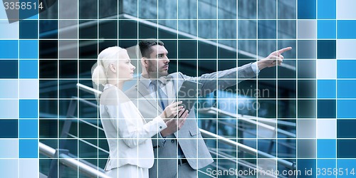 Image of serious businessmen with tablet pc outdoors