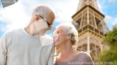 Image of happy senior couple over paris eiffel tower