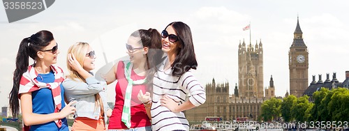 Image of happy teenage girls or young women in london city