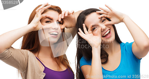 Image of two young teenagers making faces