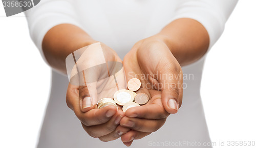 Image of womans cupped hands showing euro coins