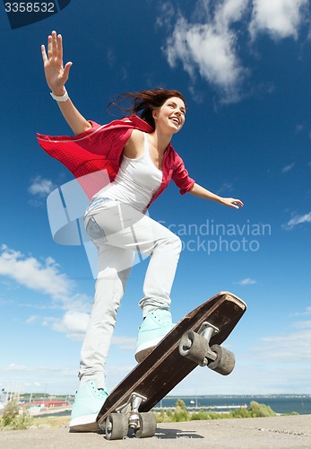 Image of teenage girl skating outside