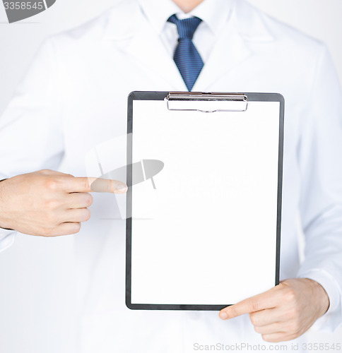 Image of doctor pointing at blank white paper