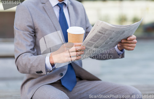 Image of close up of businessman reading newspaper