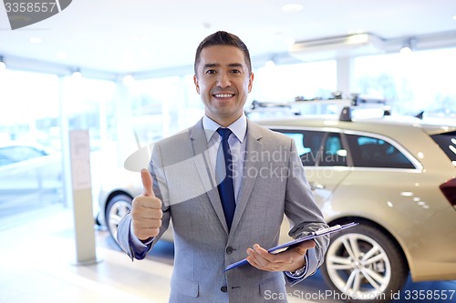 Image of happy man at auto show or car salon