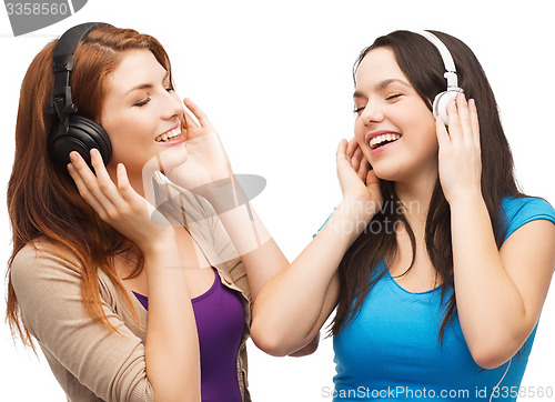Image of two smiling teenagers with headphones