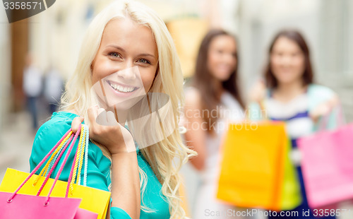 Image of beautiful woman with shopping bags in the ctiy