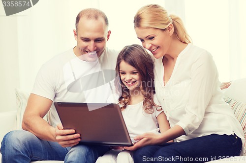Image of parents and little girl with laptop at home