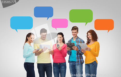 Image of group of teenagers with smartphones and tablet pc