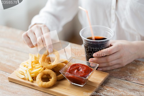 Image of close up of woman with snacks and cocacola
