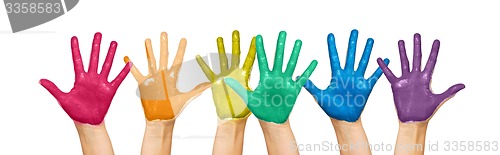 Image of palms of human hands painted in rainbow colors