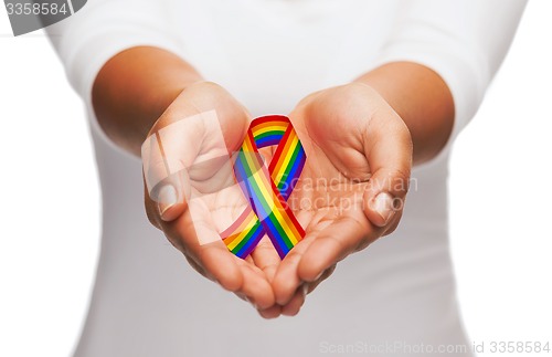 Image of hands holding rainbow gay pride awareness ribbon