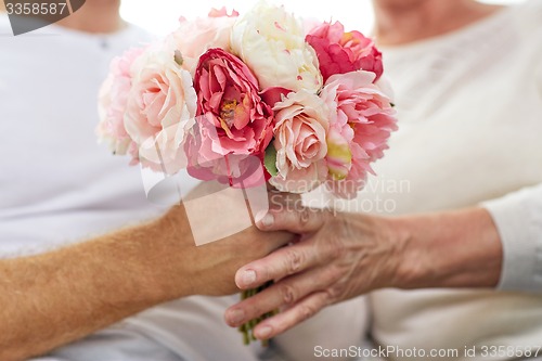 Image of close up of senior couple with flowers 