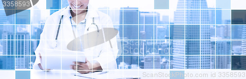 Image of happy african female doctor with tablet pc