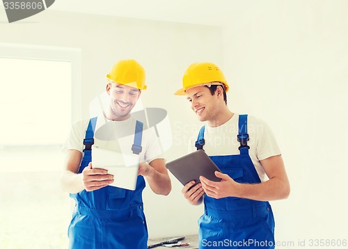 Image of builders with tablet pc and equipment indoors