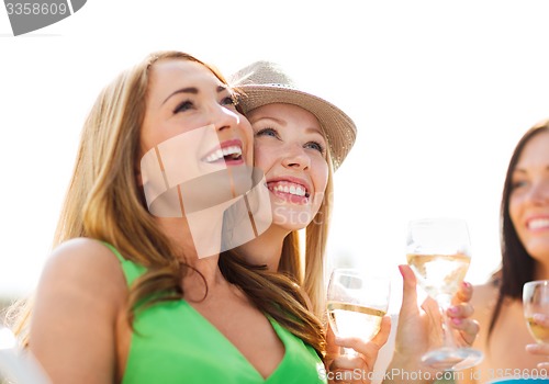 Image of girls with champagne glasses on boat