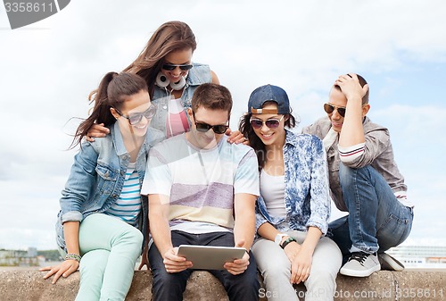 Image of group of teenagers looking at tablet pc