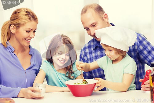 Image of happy family with two kids eating at home