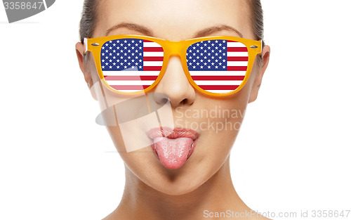 Image of happy teenage girl in shades with american flag