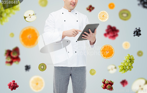 Image of close up of happy male chef cook holding tablet pc