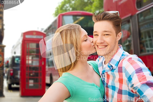 Image of happy couple taking selfie over london city