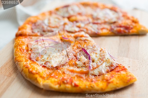 Image of close up of homemade pizza on wooden table